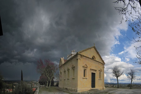 small isolated chapel with a aproaching storm in the backgroundの写真素材