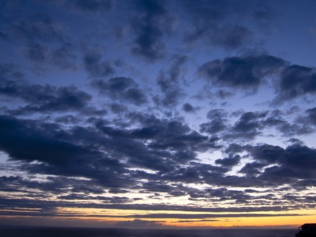 cloudy and multicolored sunset as seen in Portugal atlantic coastの写真素材