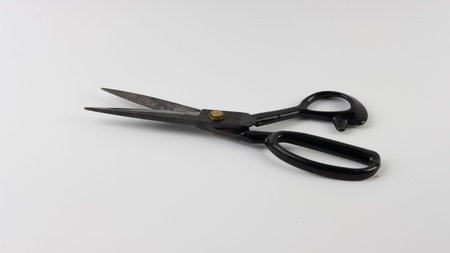 old black scissors with white screenの写真素材
