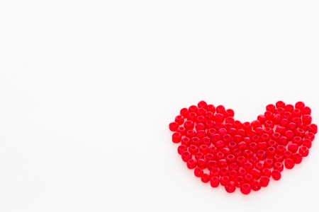 Red beads arranged as heart shapeの写真素材