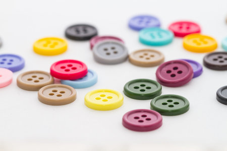 Colorful buttons spread on white background