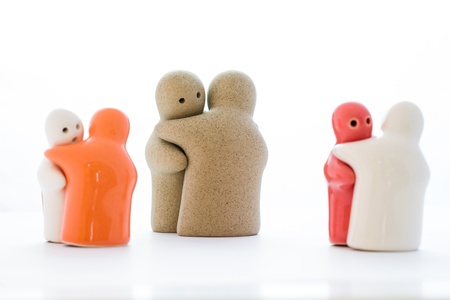 Hug by ceramic dolls on white backgroundの写真素材