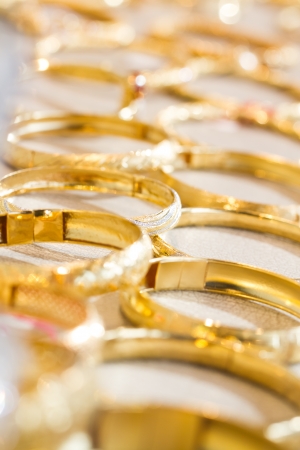 Arrangement of gold bangles in a shopの写真素材