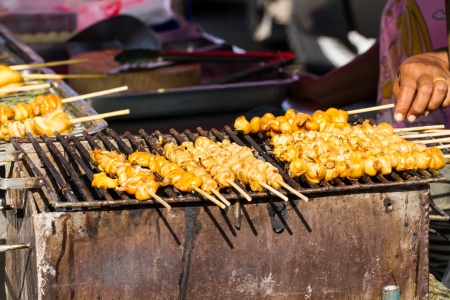 Someone grills the sticks of squidの写真素材