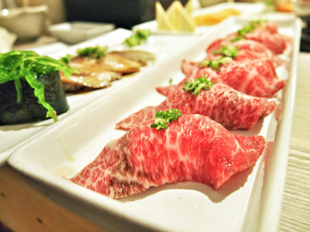 Raw beef sushi on a long plateの素材