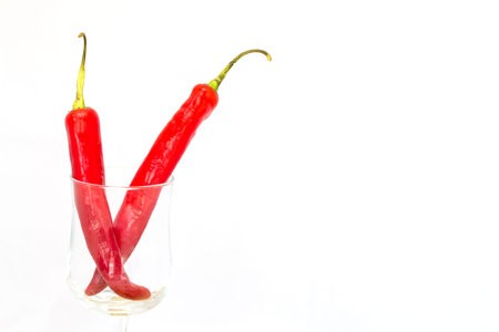 double red big chili in a glass isolatedの写真素材