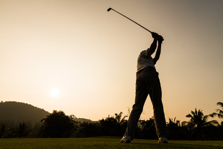 silhouette shot of golfer swing actionのeditorial素材