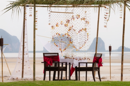 fisherman style dining table setup on the beachの写真素材