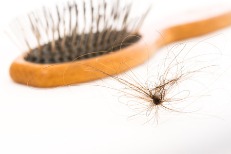 woman hair bundle and brush on white backgroundの写真素材