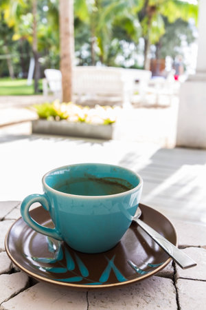 empty green cup of coffee on brown dishの写真素材