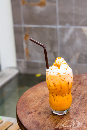 iced milk tea topped with whipping creamの写真素材