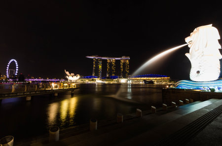 SINGAPORE - July 6, 2014 : Merlion and Marina Bay Sands by night. Merlion is a symbol of Singapore with the head of a lion and the body of fish.のeditorial素材