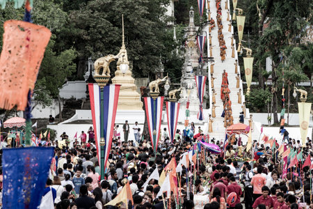 UTHAITHANI, THAILAND - OCTOBER 9 :Tak Bat Devo Festivals,The row of Buddhist monks walk down from hill to take food offering from people. October 9,2014 in Uthaithani, Thailand.のeditorial素材