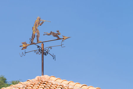 vintage wind indicator on roofの写真素材