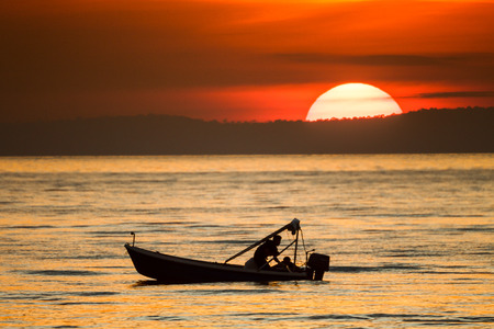 big sunset and boat in the seaの写真素材