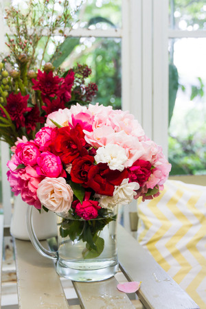 rose bouquet in glass decorated near windowの写真素材