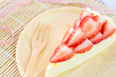 piece of strawberry tart on wood dishの写真素材