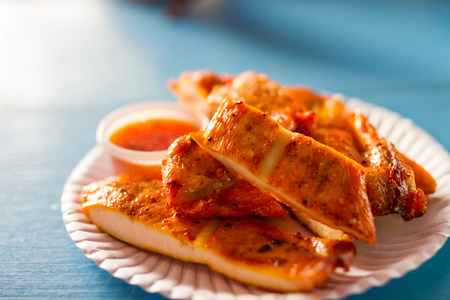 pieces of grilled chicken on paper dish, street foodの写真素材