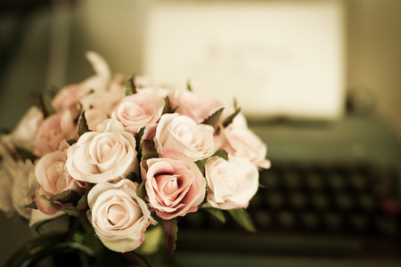 vintage flower bouquet with typewriter in backgroundの写真素材