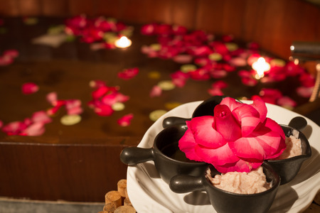 salt scrub and bath tub decorated by red rose petal in spaの写真素材