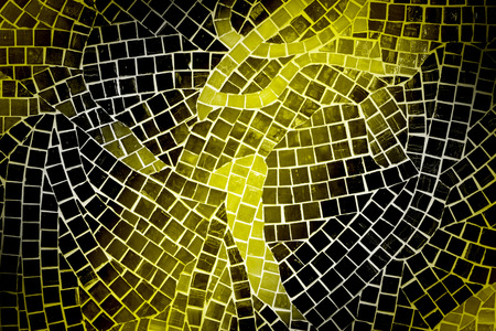rough yellow and black mosaic tile wall in bathroomの写真素材