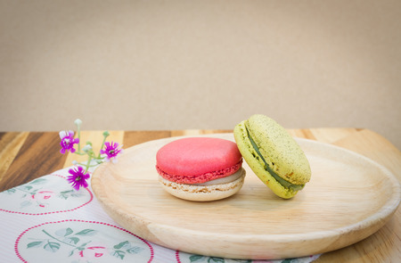 colorful macarons on wooden dish in vintage toneの写真素材