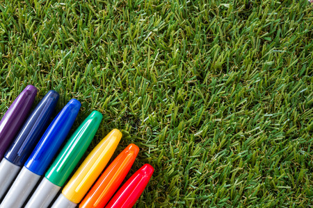 colorful cover marker pen on grassの写真素材