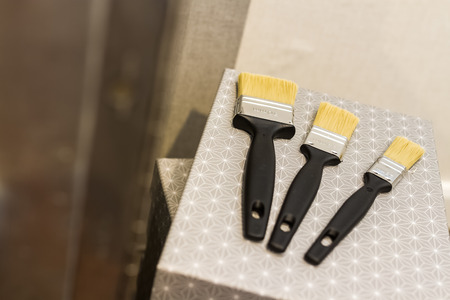 new different size paintbrushes on wood floorの写真素材