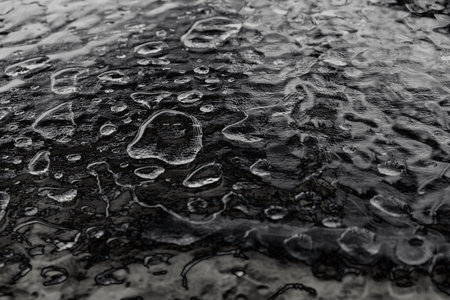 abstract raindrop texture on black glass tableの写真素材