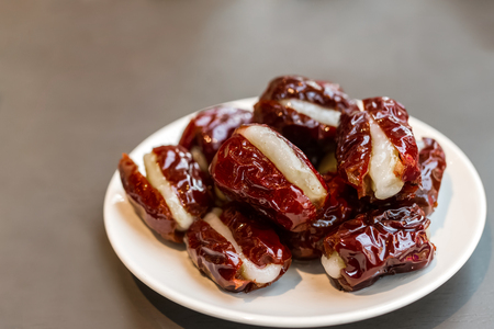 sweet dried prunes fill with steamed sticky flour served on tableの写真素材