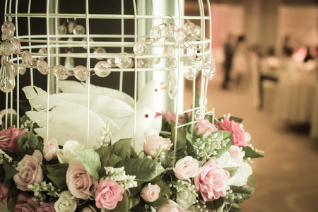 birdcage decorated with flowers at wedding receptionの写真素材