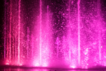 colorful water shape on fountain with black backgroundの写真素材