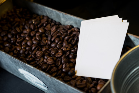blank white business cards in brown coffee beans boxの写真素材
