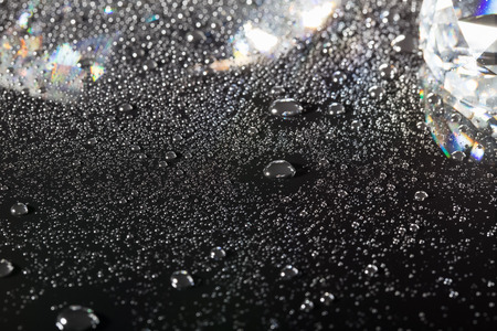 clear crystal with water drops on black backgroundの写真素材
