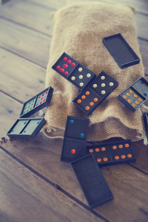 domino game from sack bag on wood table in vintage toneの写真素材