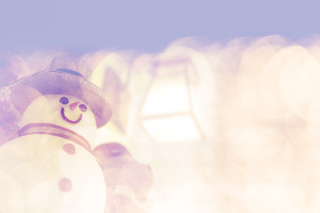 snowman doll on bright shiny bokeh backgroundの写真素材