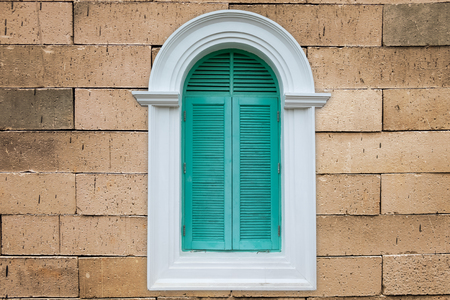 green vintage style window on brick wallの写真素材