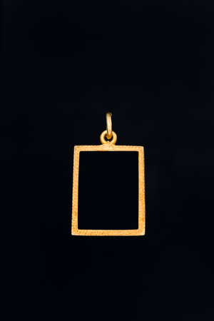 rectangle shape gold locket frame pendant on black backgroundの写真素材