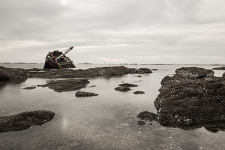 capsized fishing boat in sea at Chonburi, Thailandの写真素材