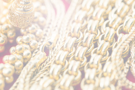 close-up pile of gold necklaces in soft tone