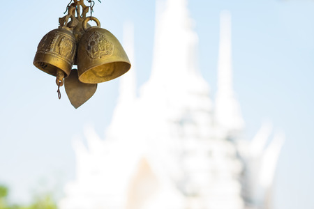 Bells hanging with temple backgroundの写真素材