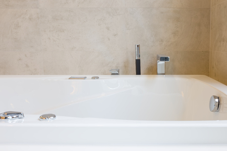 closeup faucet and bathtub in bathroomの写真素材