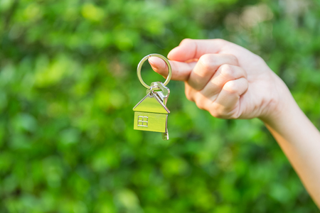 woman holding home key, real estate agent concept の写真素材