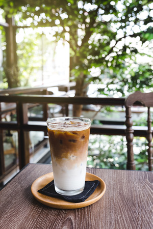 iced latte coffee on wood tableの写真素材