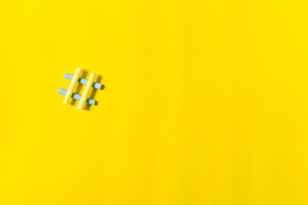 hash sign on yellow background with copy spaceの写真素材