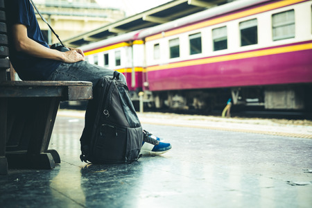 tourist sitting with bag at train station, travel conceptの写真素材
