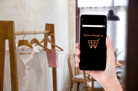 hand with smart phone for shopping service, online marketing conceptの写真素材