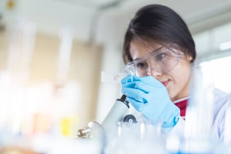 laboratory research and development concept with scientist and lab glasswareの写真素材