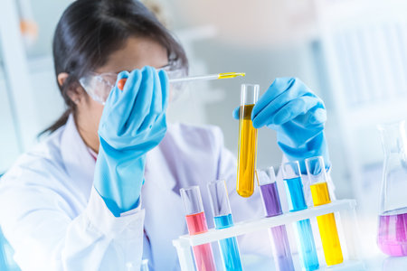 laboratory research and development concept with lab glassware and female scientist