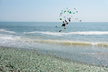 flying stones at glass beach, Vladivostok, Russiaの写真素材